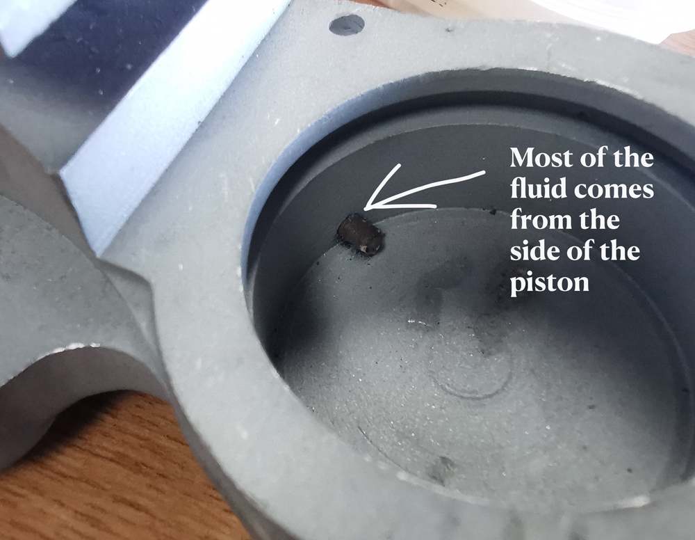 Hole at side of piston with text copy